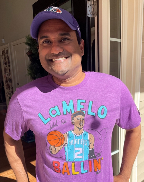 John dressed and ready for the game, sporting a LaMelo Ballin' shirt and baseball hat