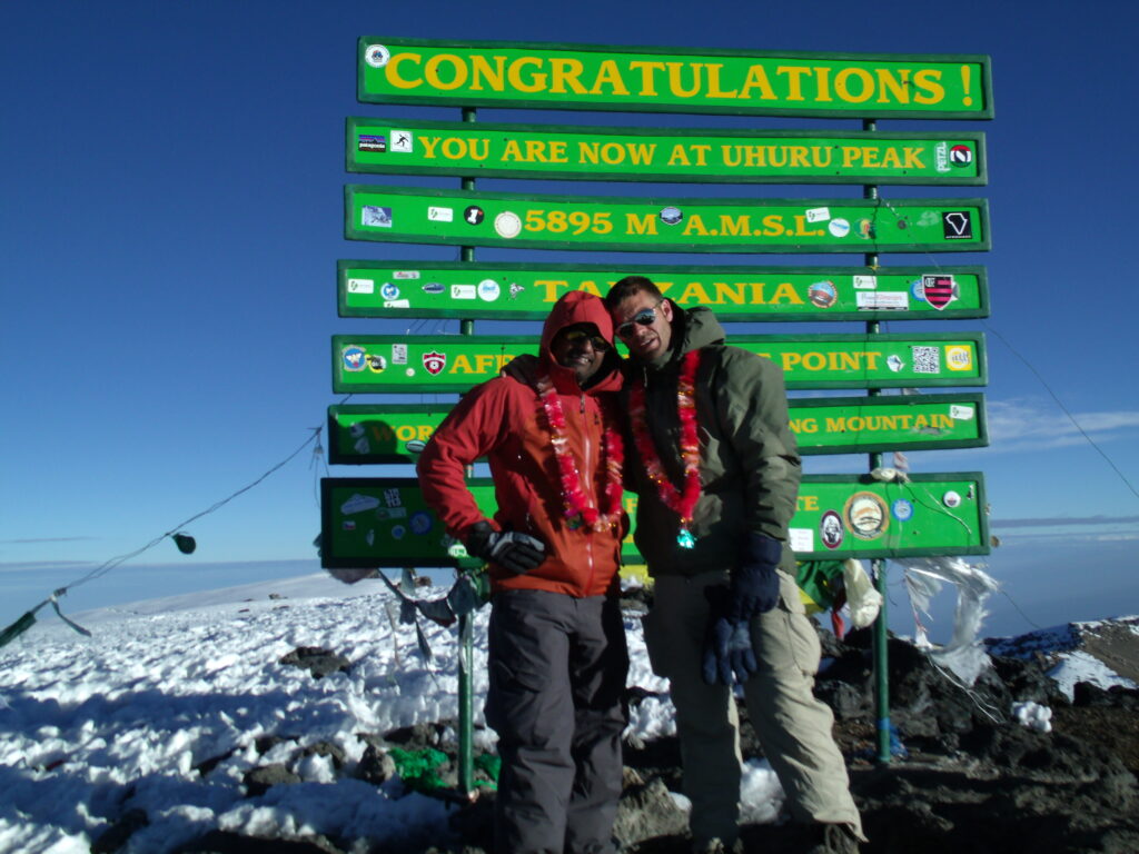 John and his guide, Stephen, standing proudly at the Uhuru Peak.