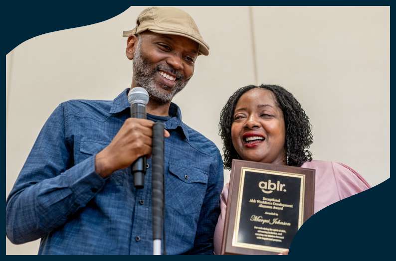 Ablr Works Instructor Shannon Garner presenting Marqui with the Exceptional Alumni Award